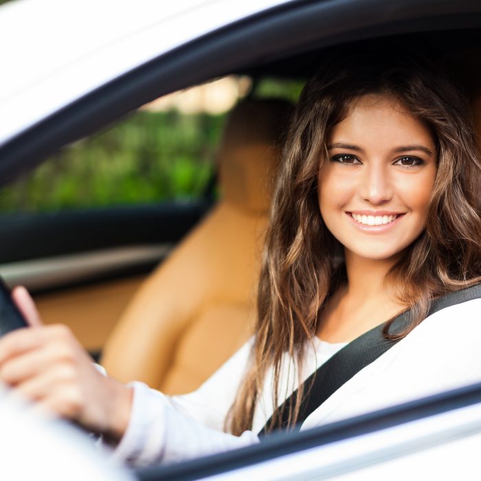Smiling Atlanta AutoStar customer driving her car